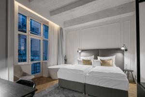 a bedroom with a large bed and a bath tub at Pytloun Boutique Hotel Prague in Prague +37 photos