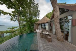 a villa with a swimming pool and a house at Song Saa Private Island in Song Saa Private Island