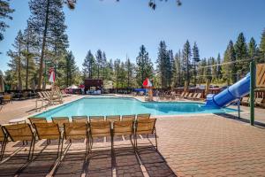 a swimming pool with chairs and a slide at Welcoming Tahoe-Donner Cabin in Truckee