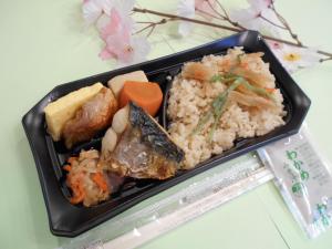 a tray of food with rice and meat and vegetables at Nishikawaguchi Station Hotel Stay Lounge in Kawaguchi