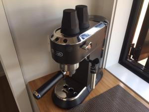 a coffee machine sitting on top of a table at Romantic vineyard getaway on Wine Estate, with wine tasting, hot tub and amazing views in Waipara