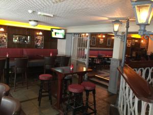 a bar with tables and chairs and a television at Kilford Arms in Kilkenny