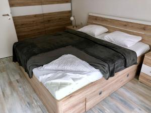a large bed with a wooden frame in a room at Bratislava Old Town Brewery - Stein in Bratislava