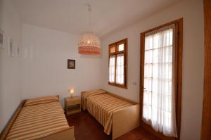 a bedroom with two beds and a window at Ville Nautilus in Bibione
