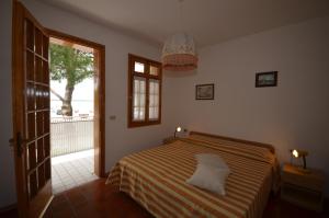 a bedroom with a bed and a large window at Ville Nautilus in Bibione