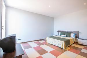 Ein Bett oder Betten in einem Zimmer der Unterkunft MOSAIC