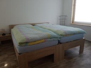 a bed sitting on a wooden platform in a room at Ferienhaus Am Graseberg in Neinstedt +5 photos