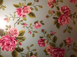 a pattern of pink flowers on a wall at Hôtel Le G (ex Le Genève) in Nice