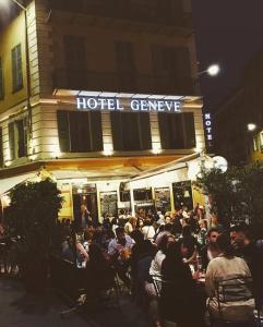 a crowd of people sitting outside of a hotel at Hôtel Le G (ex Le Genève) in Nice