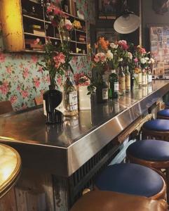 a bar with many bottles of wine and chairs at Hôtel Le G (ex Le Genève) in Nice