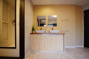 a bathroom with two sinks and a mirror at Yamato Family House - 2 Floors | 3 bedrooms in Osaka