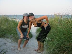 two women are posing on the sand at the beach at Ferienhaus Gut Rattelvitz Insel Rügen in Gingst