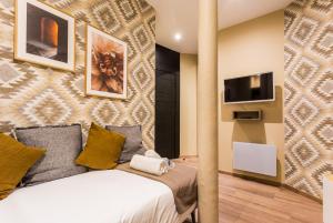 a bedroom with a bed and a tv at CMG Nation/ Vincennes in Paris