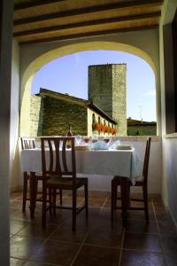 a table and chairs in a room with a window at Palazzo Alle Mura in Staggia
