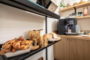 a shelf with bread and pastries on it in a kitchen at Hotel Carlton in Ghent