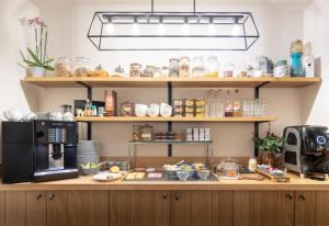 a kitchen with a counter with a microwave and a refrigerator at Hotel Carlton in Ghent