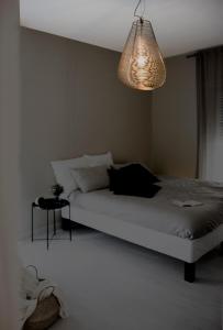 a bedroom with a bed and a chandelier at Fabrì 171 in Pescara