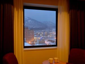 
a view from a balcony of a restaurant with a view of a city at Hakodate Kokusai Hotel in Hakodate
