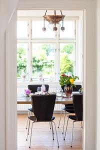 a dining room with a table and chairs and a window at The View in Borre