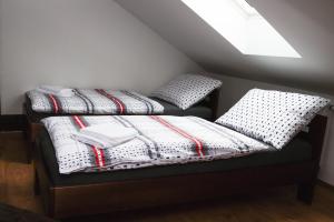 A bed or beds in a room at Apartmány RUMPA-DRINKS