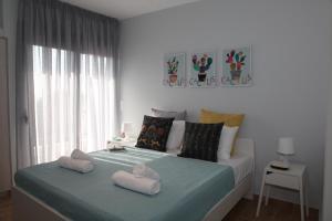 a bedroom with a bed with two towels on it at Edem Beach Apartment with Sea View by Athenian Homes in Athens