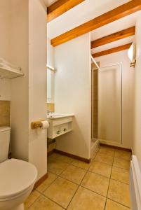 a bathroom with a toilet and a sink at AUBERGE DE LA MORENO in Saint-Genès-Champanelle
