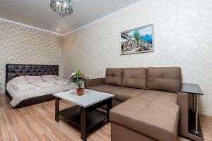sala de estar con sofá y cama en Апартаменты "Гамма ДеЛюкс", en Olginka
