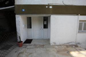 an entrance to a building with a white door at Edem Beach Apartment with Mountain View by Athenian Homes in Athens +1 photo