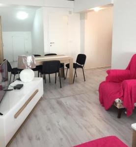 a living room with a table and chairs at Oro Apartments in Petrovac na Moru