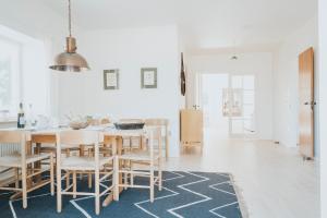 a kitchen and dining room with a table and chairs at The Light House in Borre