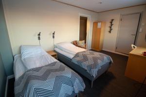 Postel nebo postele na pokoji v ubytování Lakselv Hotel