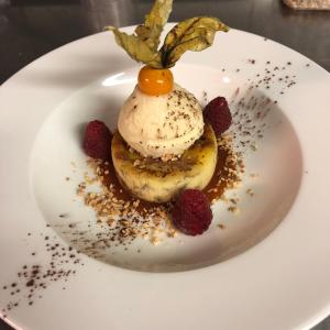 a dessert with a fruit on top of it on a plate at AUBERGE DE LA MORENO in Saint-Genès-Champanelle