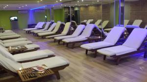 a row of chairs in a room with purple chairs at EmexOtel Kocaeli in Kocaeli