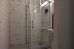 a bathroom with a shower and a sink at City Living Sentrum Hotel in Trondheim