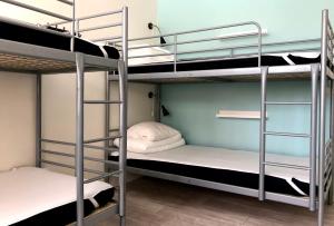 a room with two bunk beds and a room with at Örebro City Hostel in Örebro