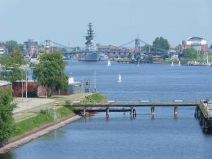 a bridge over a river with boats in the water at 129 - Ferienwohnung am Südstrand in Wilhelmshaven