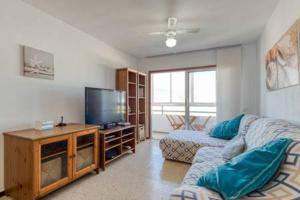 a living room with a couch and a flat screen tv at Apartment Claveles 2 in Telde