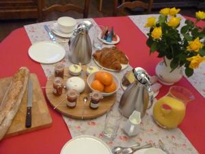 a table with a breakfast of eggs and oranges on it at chateau de Craon in Comblessac