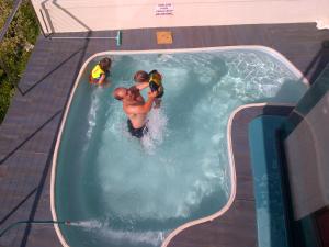 a group of people in a swimming pool at Royal Albatros in Gansbaai