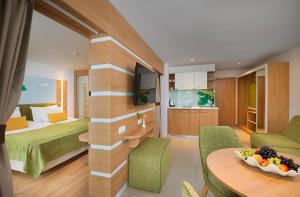 a hotel room with a bed and a table at Hotel Forest Beach in Primorsko +37 photos