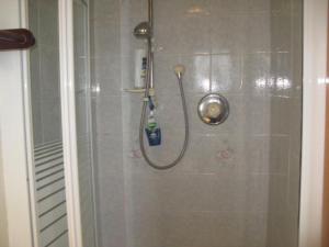 a shower with a shower head in a bathroom at The Anchorage in Ose