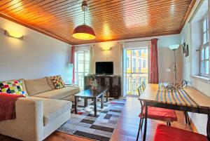 a living room with a couch and a table at MyPlaceLisbon - Alfama River View Apartment in Lisbon