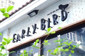 a sign for a bakery on the side of a building at Early Bird Hostel Ayutthaya in Phra Nakhon Si Ayutthaya