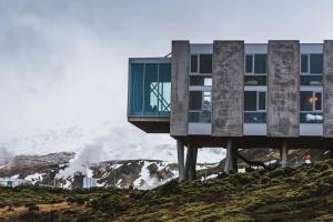 a building on top of a hill with a mountain at ION Adventure Hotel, Nesjavellir, a Member of Design Hotels in Nesjavellir