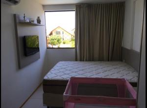 a small bedroom with a bed and a window at Muro Alto Flat Nui Supreme in Porto De Galinhas +27 photos
