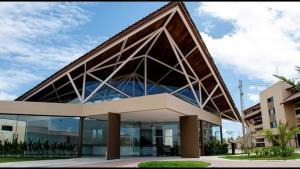 a large building with a large angled roof at Muro Alto Flat Nui Supreme in Porto De Galinhas