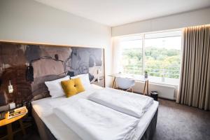 Ліжко або ліжка в номері Comwell Hvide Hus Aalborg