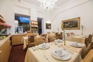 a restaurant with tables and chairs and a chandelier at Hotel The Lord in Ghent