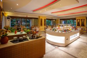 a restaurant with a food counter in a building at Pantheon Hotel in Rethymno