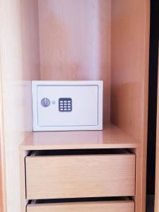 a microwave sitting on a shelf in a closet at Quinta dos Arcos Feel At Home in Armação de Pêra